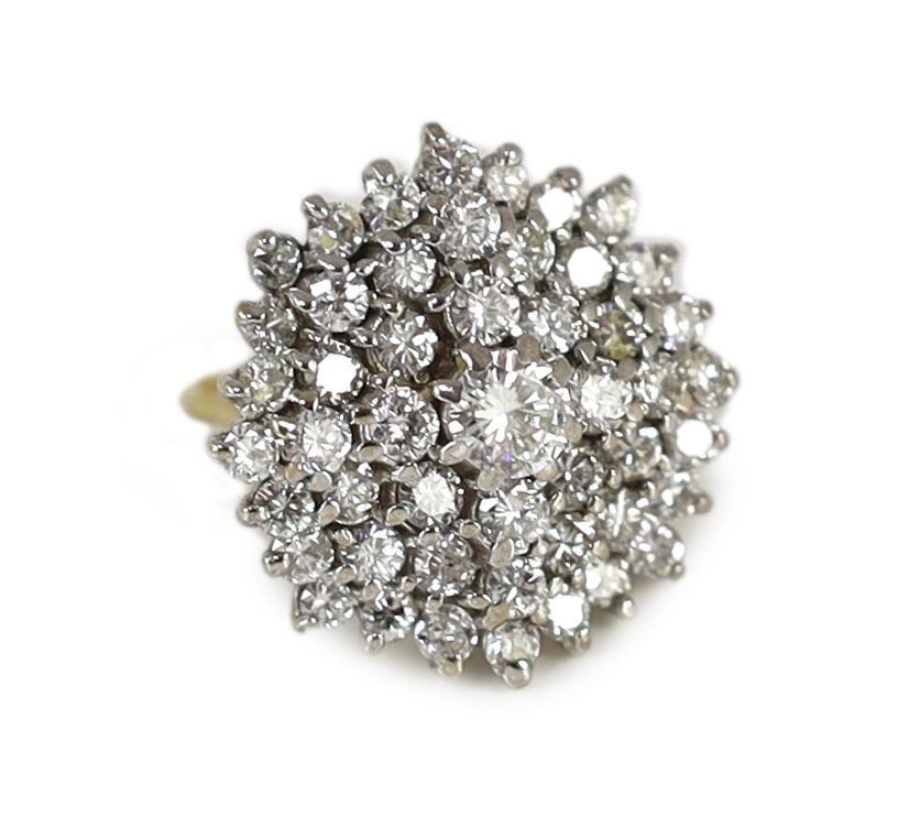 An impressive gold, platinum and diamond set circular cluster ring